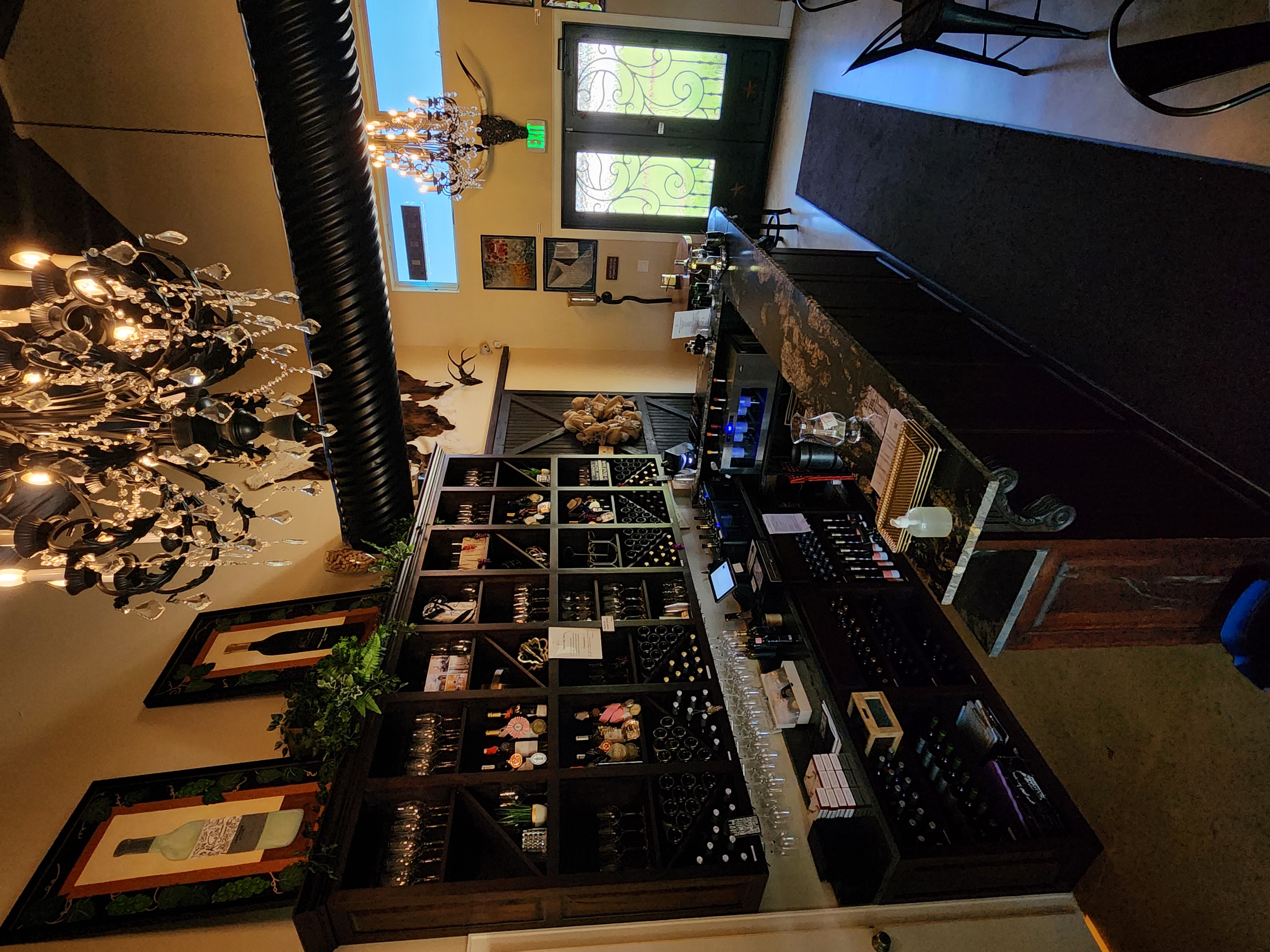 Kai-Simone Winery tasting room interior with wine display and chandelier